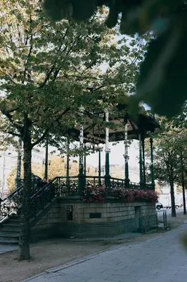 a building with a staircase and some trees and flowers at Kouter House in Ghent