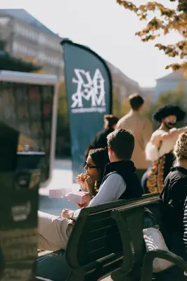 a group of people sitting on a park bench at Kouter House in Ghent