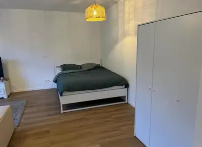 a small bedroom with a bed and a closet at Beautiful and Cosy Flat in Etterbeek in Brussels