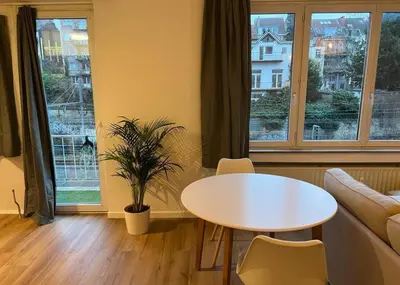 a living room with a white table and a couch at Beautiful and Cosy Flat in Etterbeek in Brussels