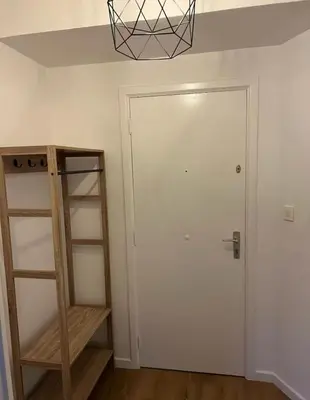 a room with a white door and a shelf at Beautiful and Cosy Flat in Etterbeek in Brussels