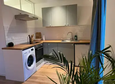 a kitchen with a washing machine and a sink at Beautiful and Cosy Flat in Etterbeek in Brussels