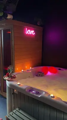 a hot tub with a sign that says love at Maison Soleya Brussels, private spa and love room in Asse