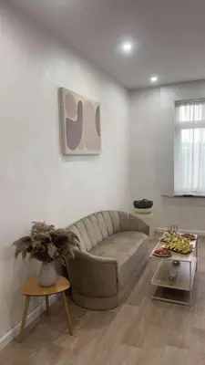 a living room with a couch and a table at Maison Soleya Brussels, private spa and love room in Asse