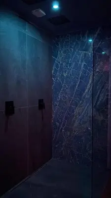 a bathroom with a glass shower stall with a map on the wall at Maison Soleya Brussels, private spa and love room in Asse