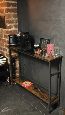 a wooden table with a telephone on top of it at Maison Soleya Brussels, private spa and love room in Asse