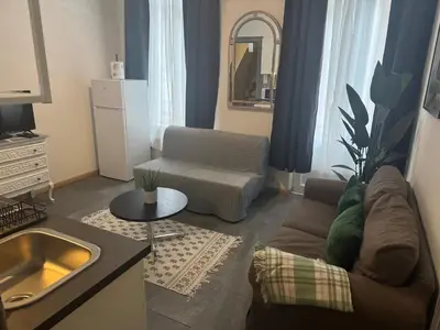 a living room with a couch and a table at La Perla Appartements Louise in Brussels