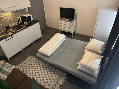 a small kitchen with a bed with pillows on it at La Perla Appartements Louise in Brussels