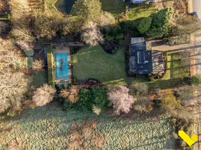 an aerial view of a house with a yard at Wezelhoeve in Mol