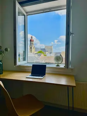 a laptop sitting on a desk in front of a window at Antwerp City Nest in Antwerp