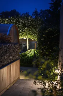 a backyard at night with a fence and a garden at Relax Ohm in Zottegem