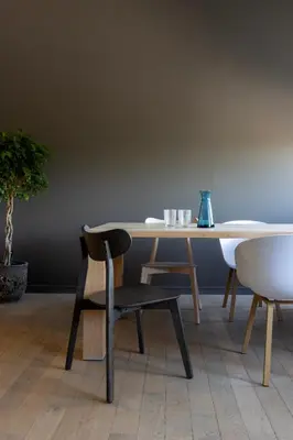 a dining room table with a chair and a table at Relax Ohm in Zottegem