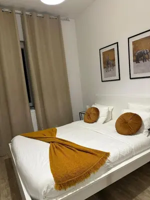 a bedroom with a bed with two pillows on it at A little love nest in Brussels