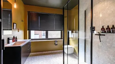 a bathroom with a sink and a toilet and a window at Porta Superia Boutique B&B in Mechelen