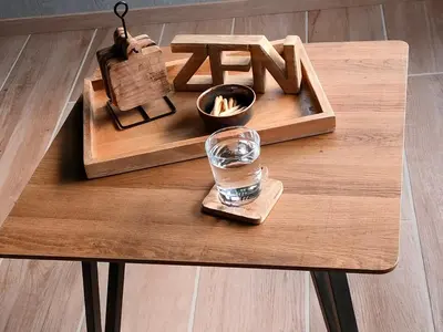 a wooden coffee table with a glass of water on it at Het Karperhuisje in Geel