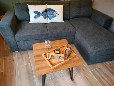 a living room with a couch and a coffee table at Het Karperhuisje in Geel
