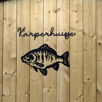 a fish painted on the side of a wooden wall at Het Karperhuisje in Geel