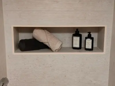 a medicine cabinet with two bottles and a towel at Het Karperhuisje in Geel