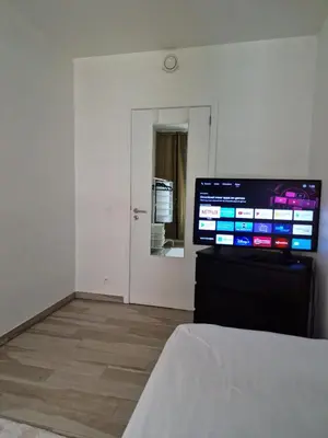 a room with a flat screen tv sitting on a dresser at collocation en metro erasme in Brussels