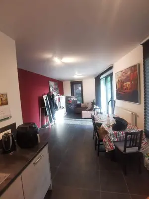 a kitchen and living room with a table and chairs at collocation en metro erasme in Brussels