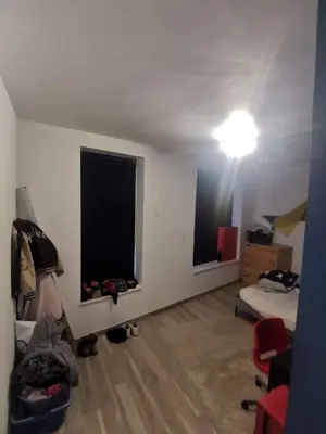 a room with a bed and a light on the ceiling at collocation en metro erasme in Brussels
