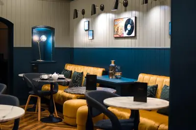 a restaurant with two tables and chairs and a table and two tables at Dansaert Hotel in Brussels