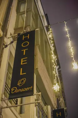 a black sign on the side of a building at Dansaert Hotel in Brussels