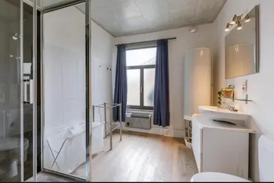 a bathroom with a tub and a sink and a shower at Sweet home in Ghent