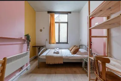 a small bedroom with a bed and a window at Sweet home in Ghent