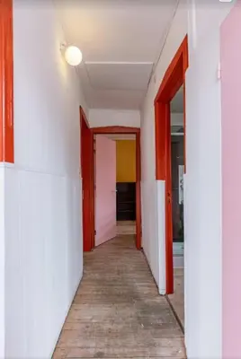 a corridor of an empty room with red doors at Sweet home in Ghent
