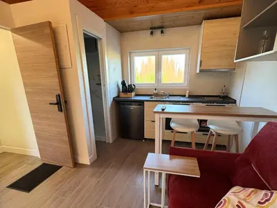 a small kitchen with a table and a red couch at WelKom Studios in Zaventem