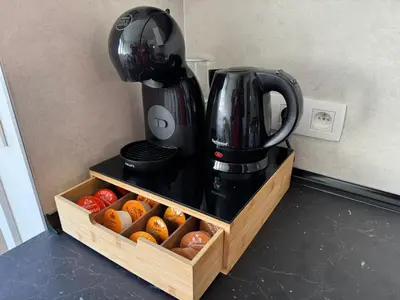 a coffeemaker sitting on top of a counter next to a box of fruit at WelKom Studios in Zaventem