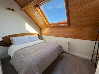 a bedroom with a large bed with a window at WelKom Studios in Zaventem