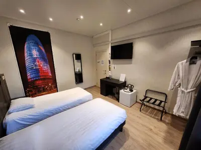 a hotel room with two beds and a desk at Albert 2 - Basic Room in Mechelen