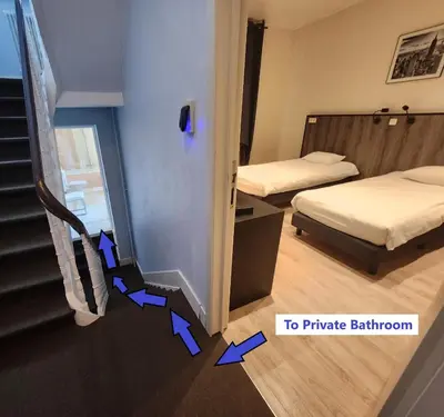 two beds in a hotel room with arrows pointing into a room at Albert 2 - Basic Room in Mechelen
