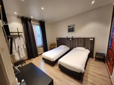a hotel room with two beds and a table at Albert 2 - Basic Room in Mechelen