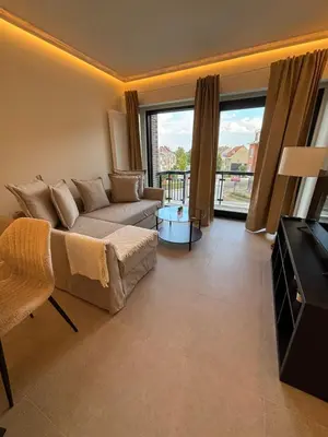a living room with a couch and large windows at Luxury 1 Bedroom Apartment with Sofa Bed & Balconies Prime Location near ING Arena, Expo 12 & Atomium in Wemmel