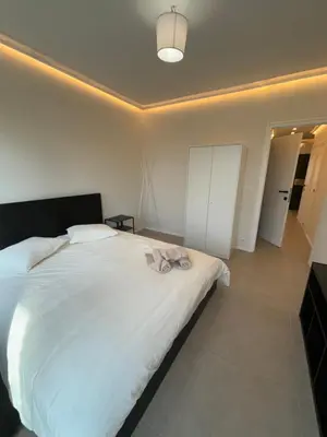 a bedroom with a large white bed in a room at Luxury 1 Bedroom Apartment with Sofa Bed & Balconies Prime Location near ING Arena, Expo 12 & Atomium in Wemmel