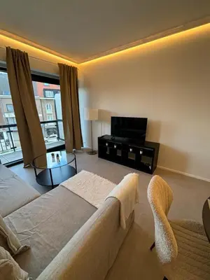 a living room with a couch and a flat screen tv at Luxury 1 Bedroom Apartment with Sofa Bed & Balconies Prime Location near ING Arena, Expo 12 & Atomium in Wemmel