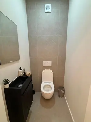 a small bathroom with a toilet and a sink at Luxury 1 Bedroom Apartment with Sofa Bed & Balconies Prime Location near ING Arena, Expo 12 & Atomium in Wemmel