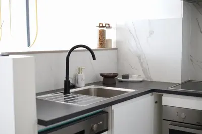 a kitchen with a sink and a counter top at A Marbled Touched Haven in Antwerp