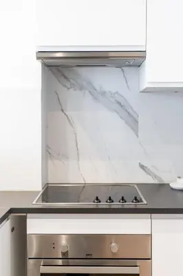 a kitchen with white marble counter tops and a stove at A Marbled Touched Haven in Antwerp