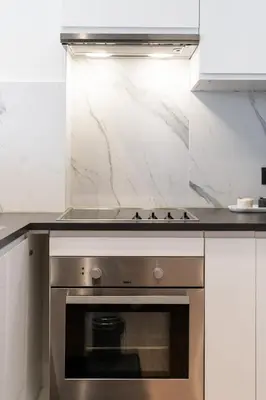 a kitchen with a stainless steel stove top oven at A Marbled Touched Haven in Antwerp