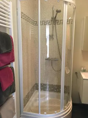 a shower with a glass enclosure in a bathroom at Guesthouse De Middelvelden in Arendonk