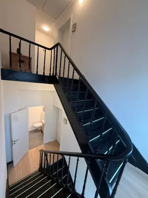 a spiral staircase in a house with a bathroom at The Gallery Saint-Gilles in Brussels