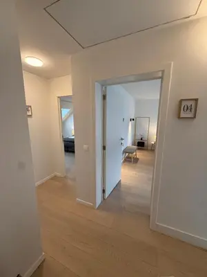 a hallway with an open door to a living room at The Gallery Saint-Gilles in Brussels
