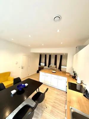 a large living room with a table and chairs at The Gallery Saint-Gilles in Brussels