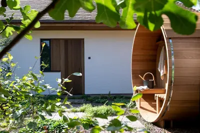 a house with a pivot door in a garden at B&Biotope in Heusden