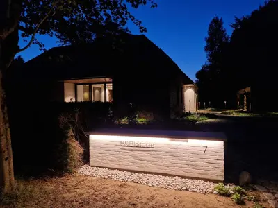a white wall with the word melbourne on it at night at B&Biotope in Heusden