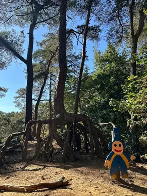 a scarecrow stands in front of a tree structure at Guesthouse Eekhoorn 16 in Kasterlee